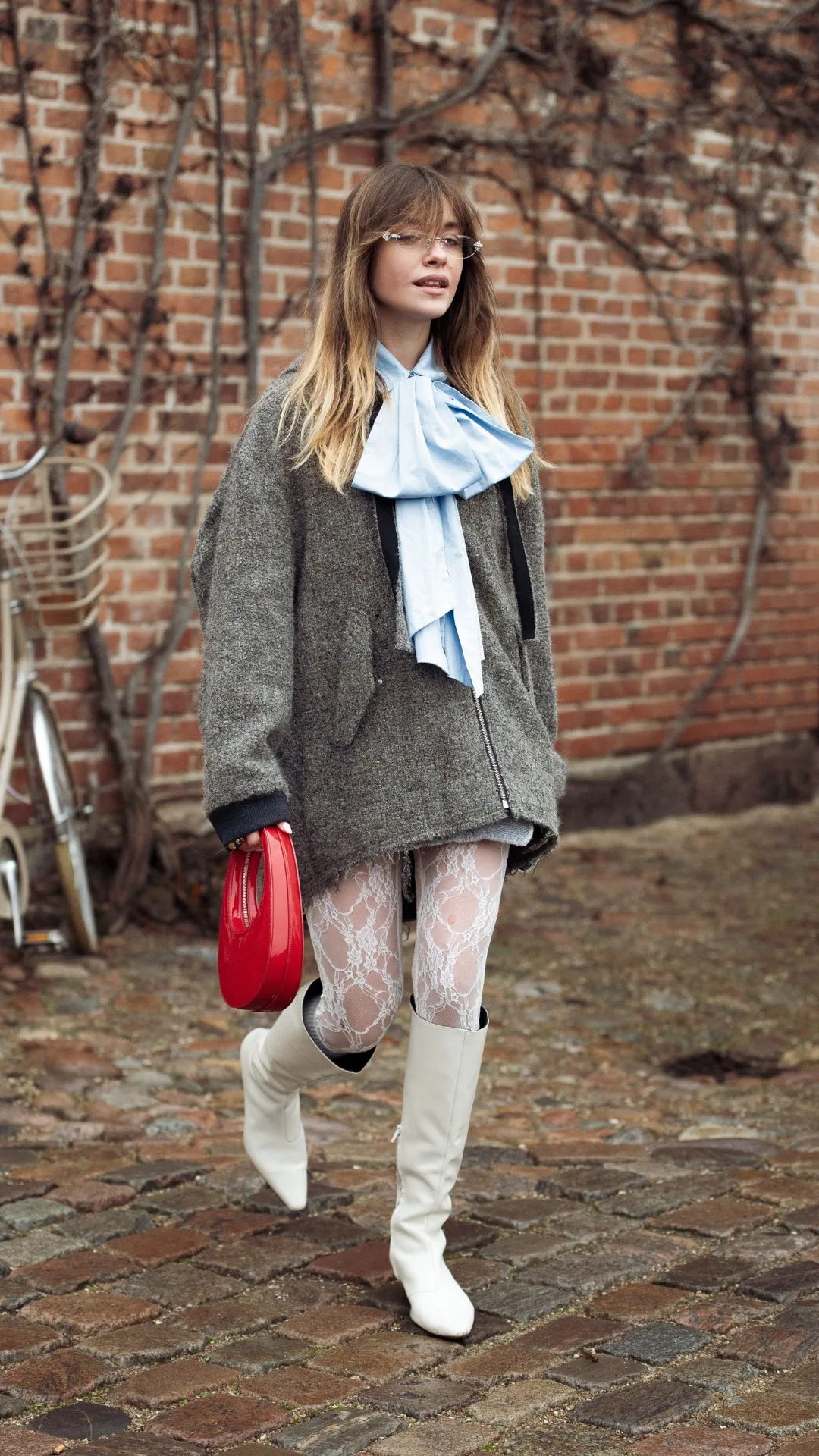 copenhagen street style fashion week autumn winter 2025 woman wears pussybow blouse