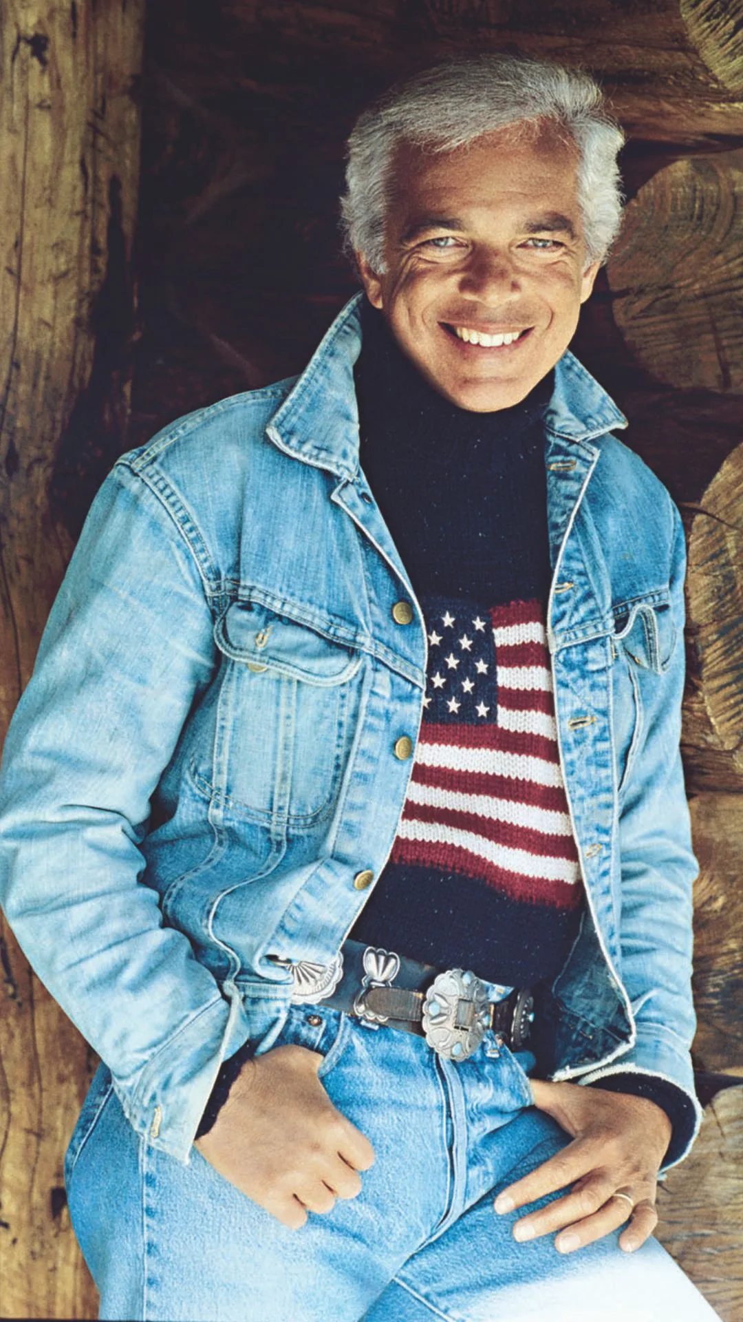 Ralph Lauren has been honoured with the Presidential Medal of Freedom. Pictured here wearing a signature Ralph Luaren American flag jumper and double denim.