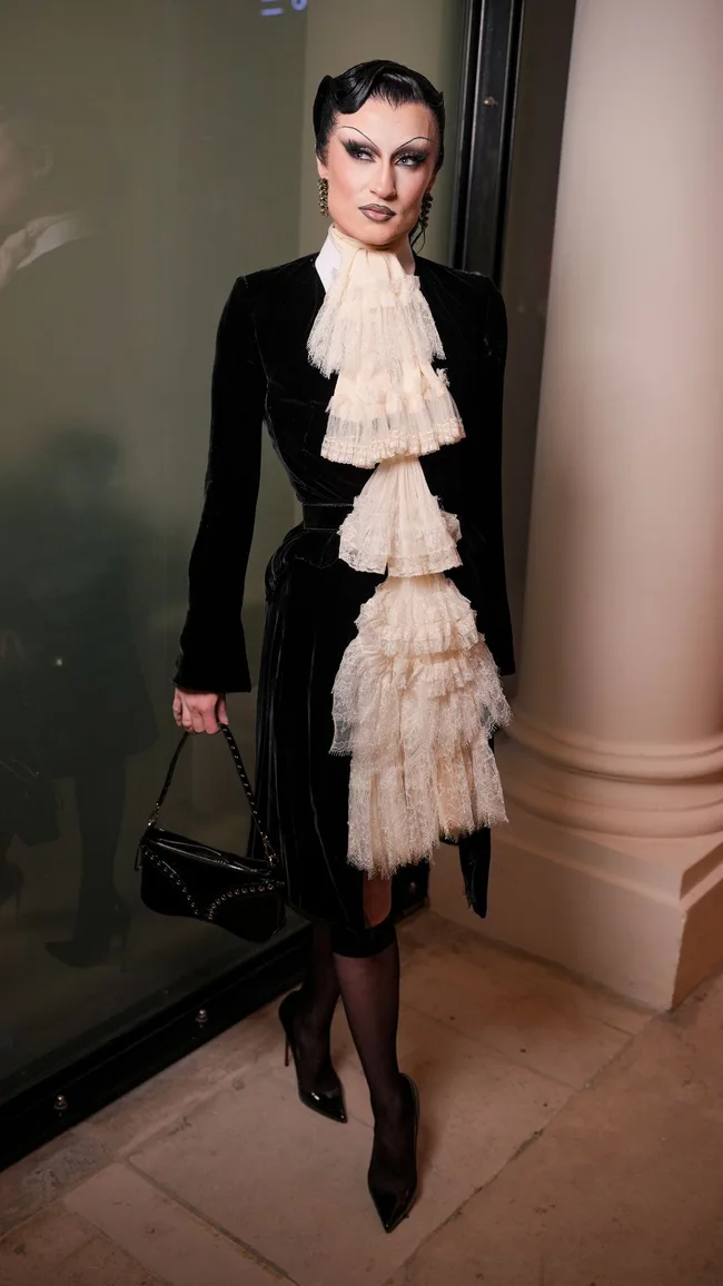 haute couture celebrity style gottmik in black velvet dress with lace cravat at jean paul gaultier