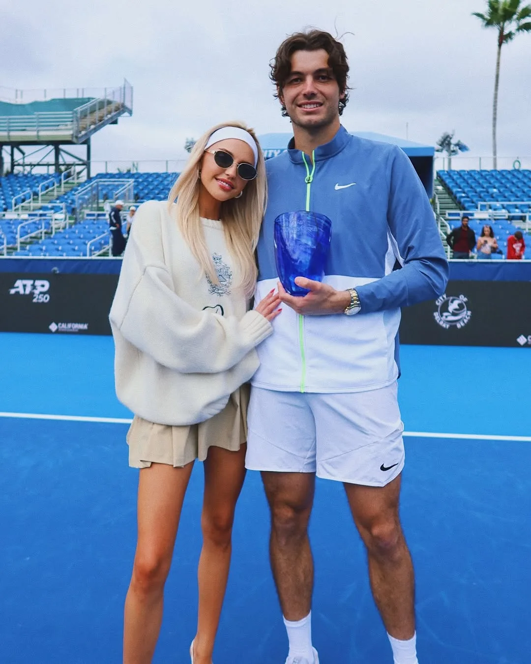 taylor fritz with girlfriend morgan riddle on blue tennis court