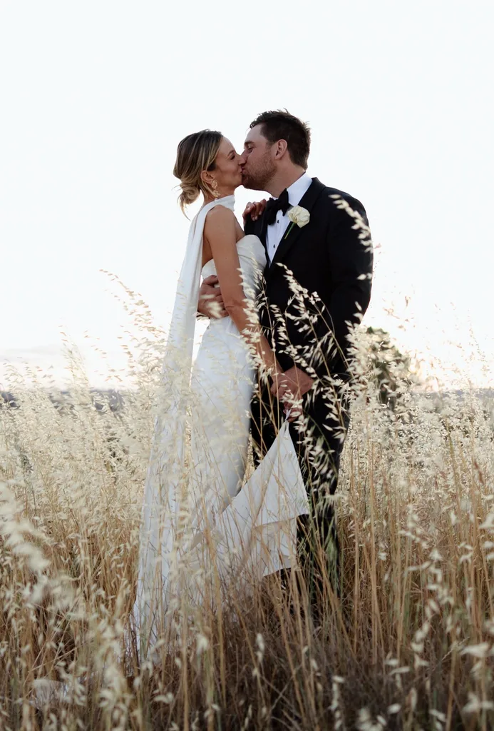 Eliza and Jack Sykes kissing in a field