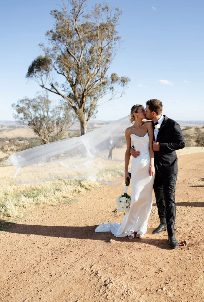 Eliza Sykes and Jack Sykes kissing post ceremony