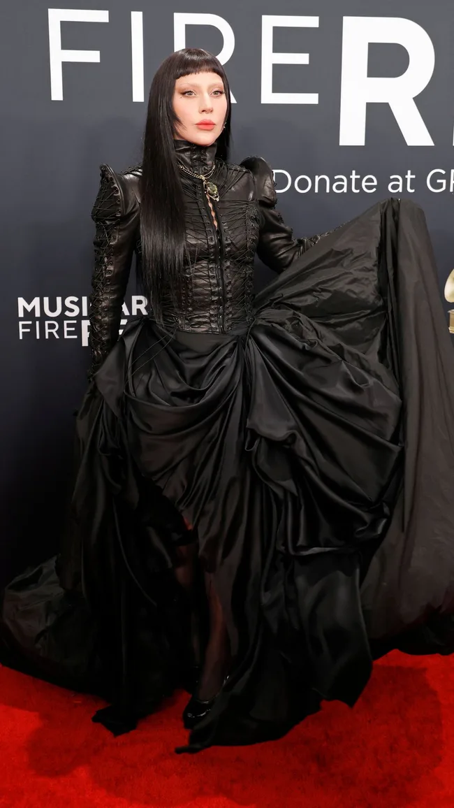 lady gaga on the 2025 grammys red carpet wearing a victorian gothic black gown
