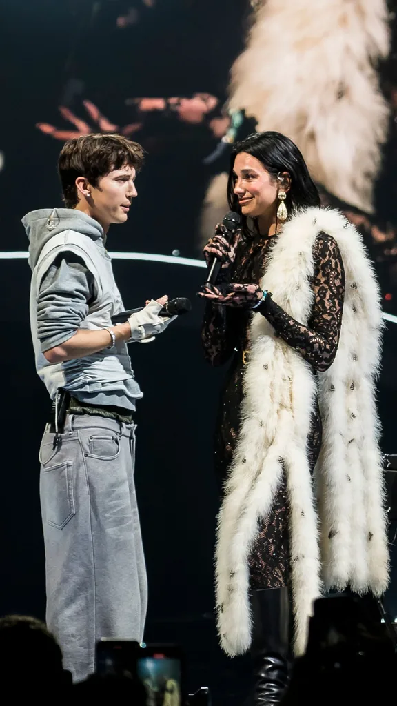 Troye Sivane and Dua Lipa on stage. Dua Lipa is wearing Valentino