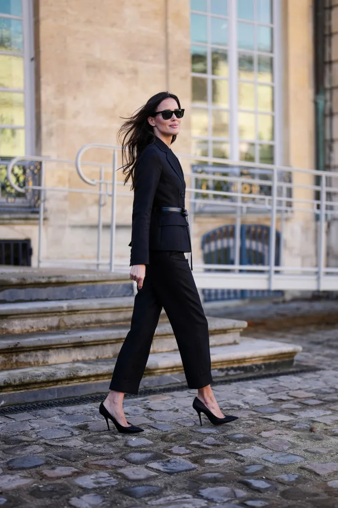 chic woman in pants suit in paris in high heels and sunglasses