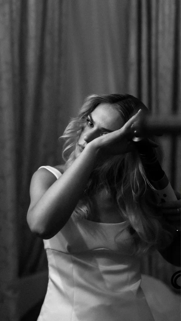 Samara fixing her hair