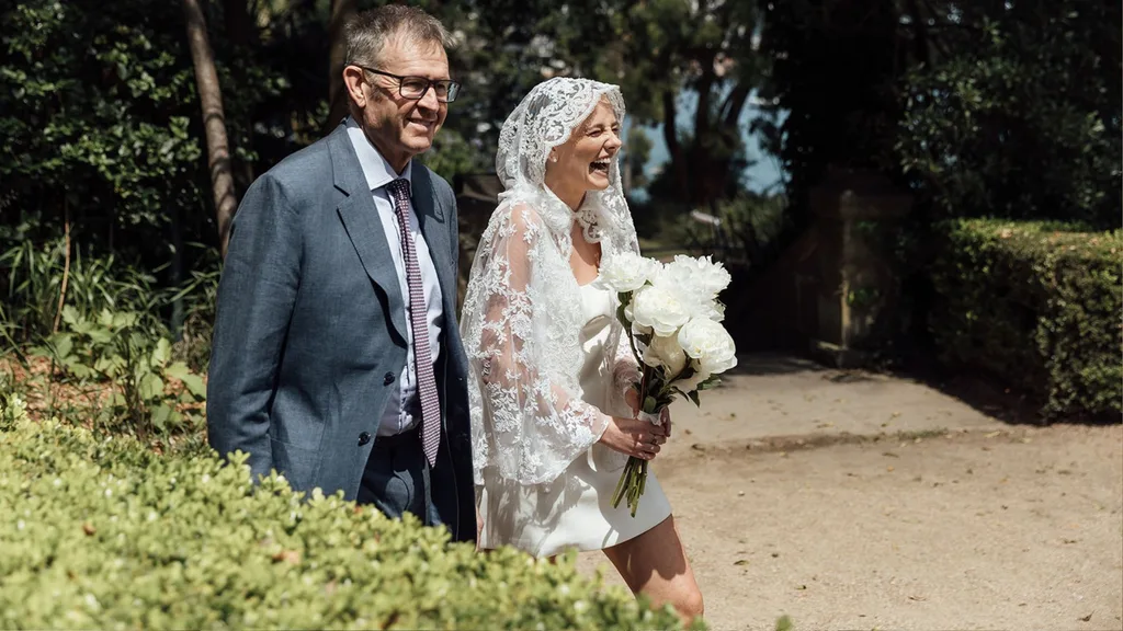 Molly walking down the aisle with her father