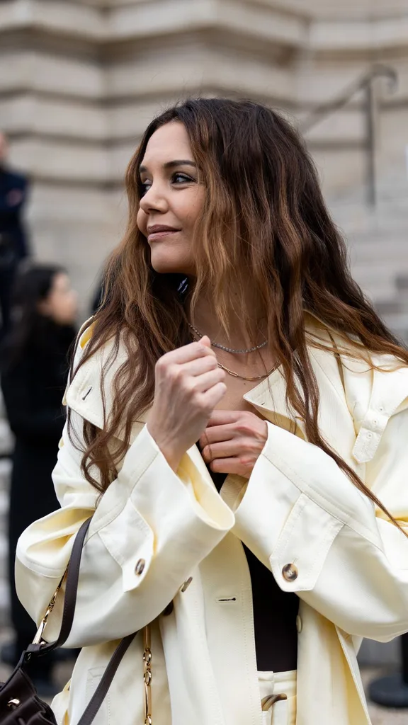 Katie Holmes wears gold earrings, a diamond necklace at Paris Fashion Week 2025 in Paris, France