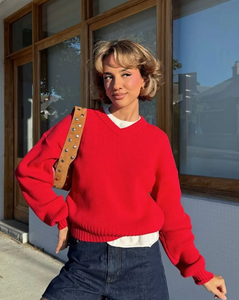 Girl wearing bright red Venroy jumper