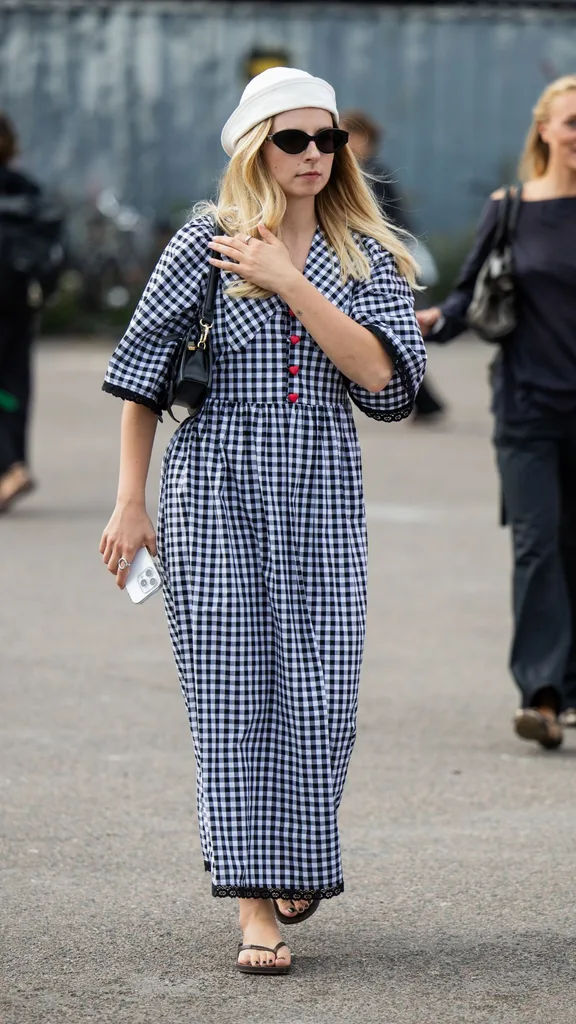 Woman wearing gingham dress and thongs