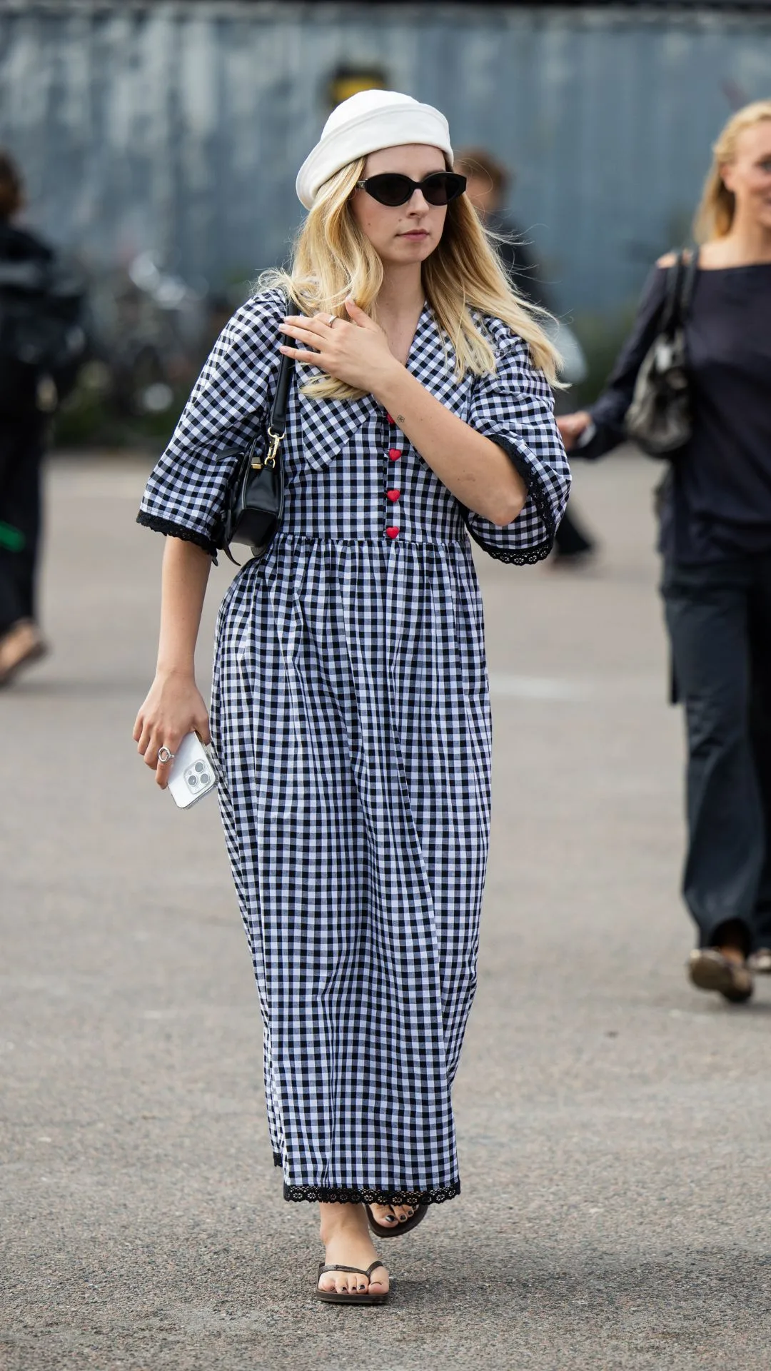 Woman wearing gingham dress and thongs 