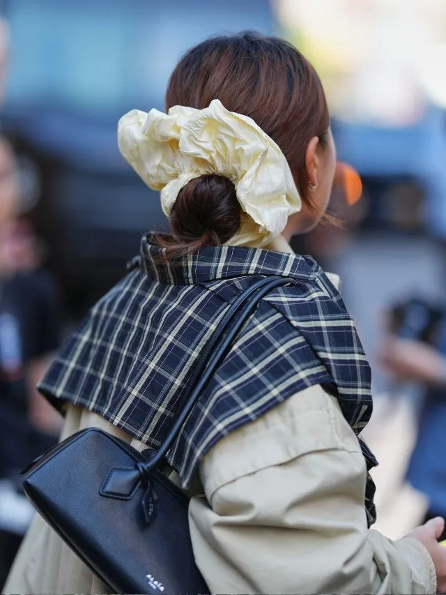 new york fashion week atendee wearing oversized butter yellow scrunchie 