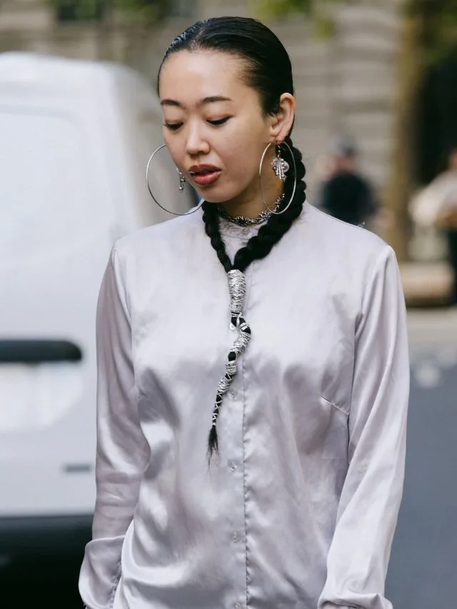 Guest at London Fashion Week with braid worn as necklace 