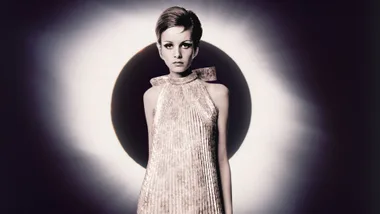 Twiggy standing in front of a lunar eclipse