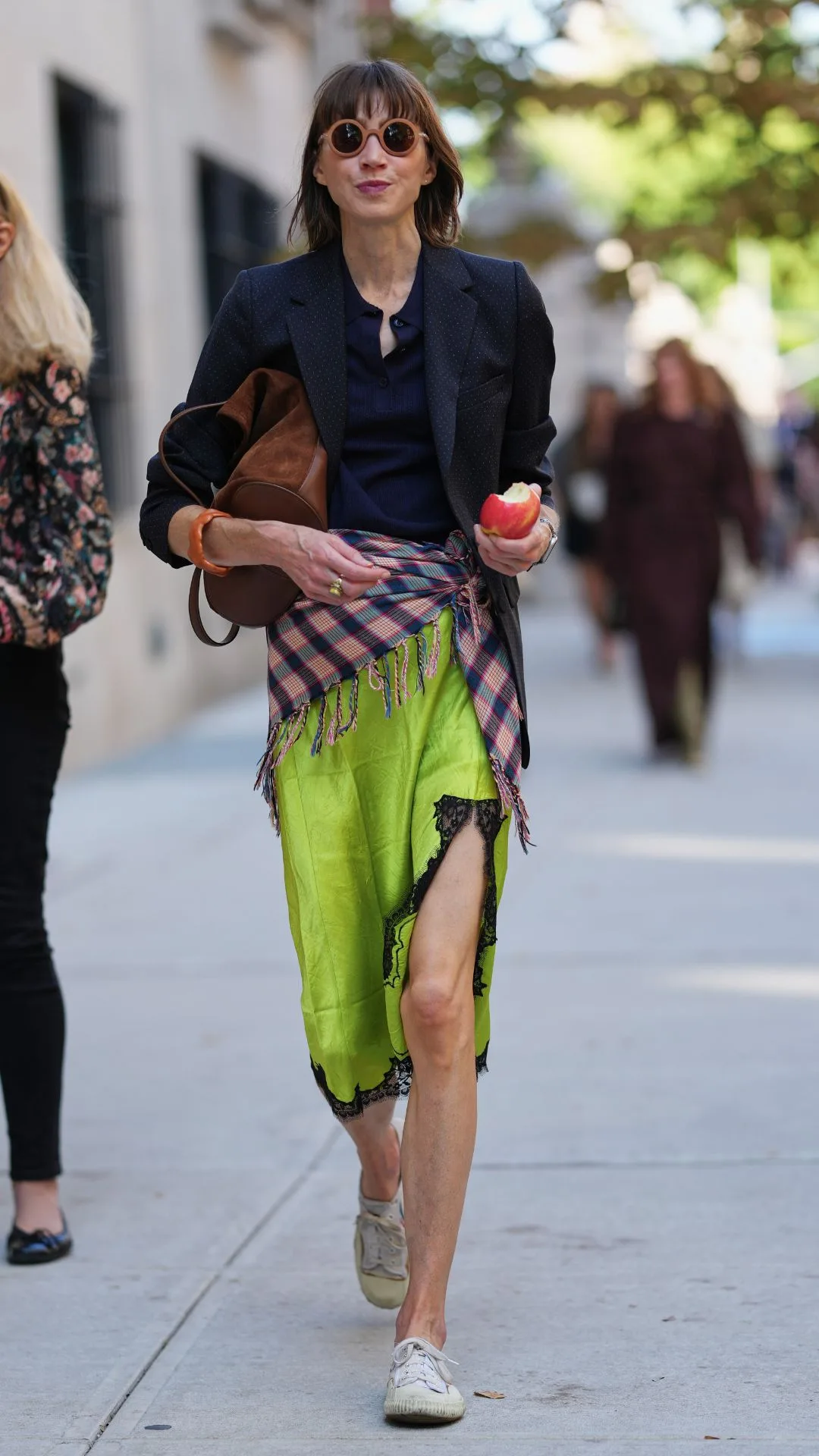 Guest at NYFW wears acid green slip skirt with chequered scarf tied around the waist 