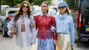 Three women in a street style photo