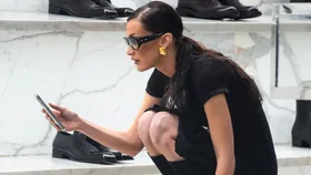 Bella Hadid looking at phone while shopping