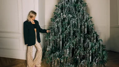 woman hanging things on christmas tree