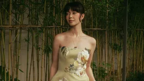 Tara Milk Tea wears green floral wedding guest dress by Leo Lin