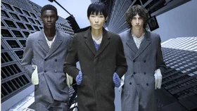 Models from the prada runway in front of a city-scape