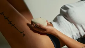 a women holding a small vibrator