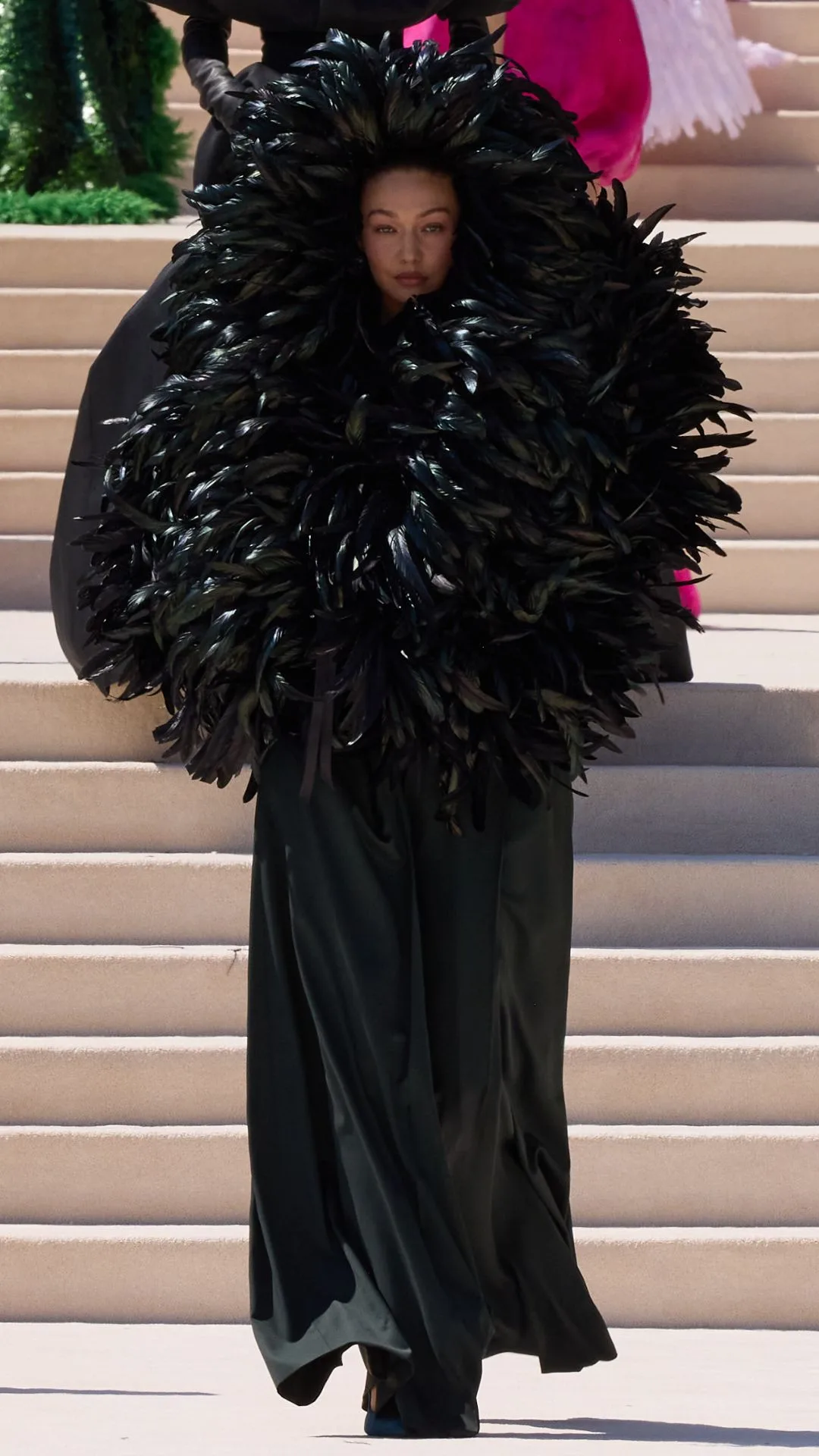 Gigi hadid wearing a black feathered balenciaga hood dress 