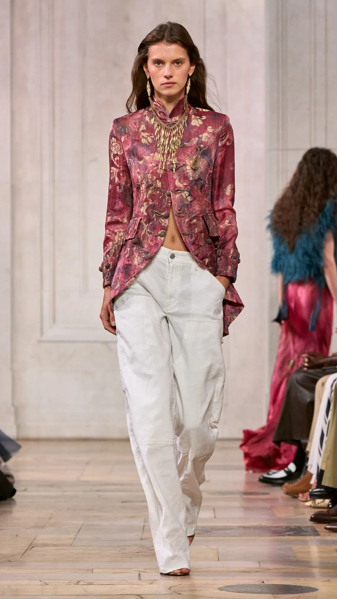 A look from the Ralph Lauren show with the model wearing a pink brocade and white jeans. 