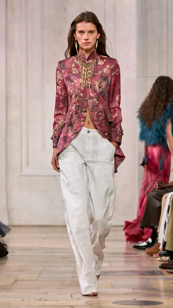 A look from the Ralph Lauren show with the model wearing a pink brocade and white jeans.