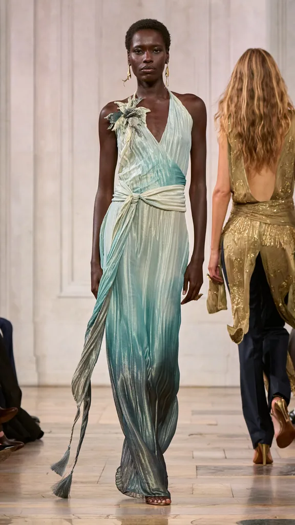 A look from the Ralph Lauren show with the model wearing a blue gradient V-neck maxi gown.