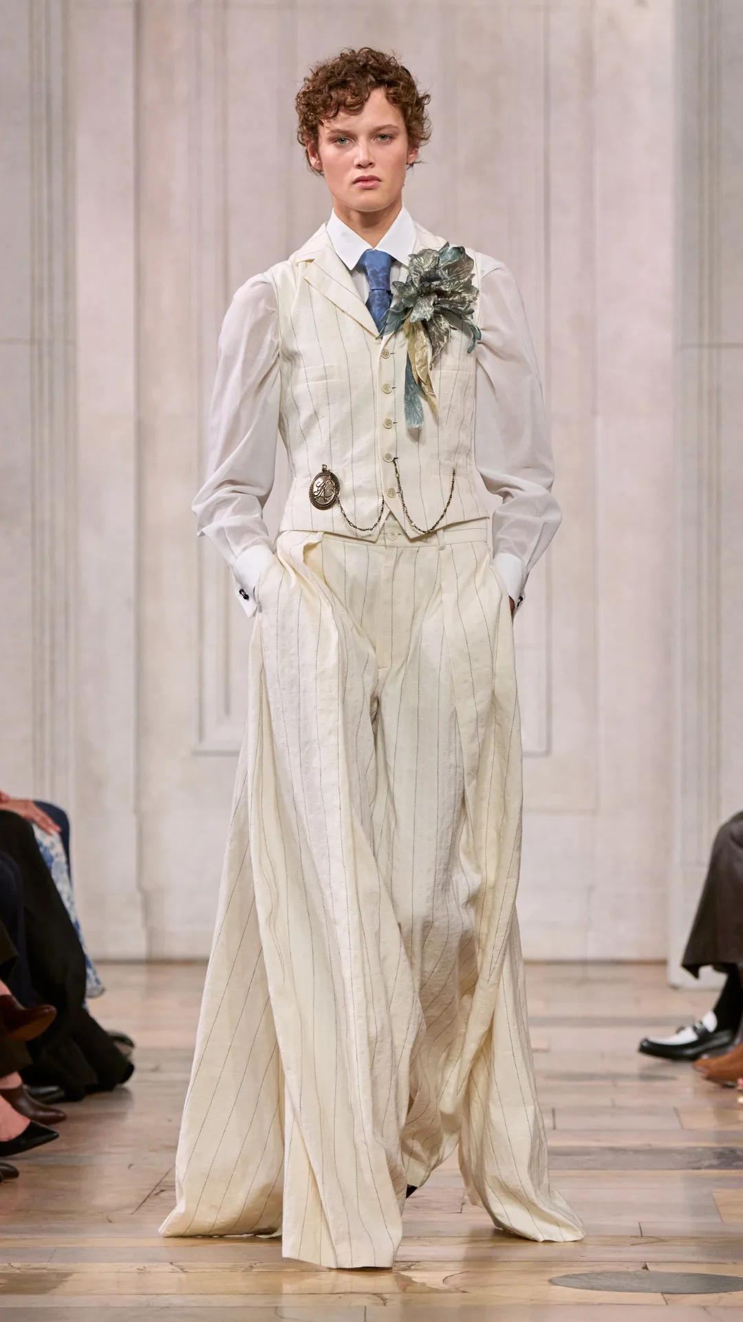 A look from the Ralph Lauren show with the model wearing a white pinstriped trouser and vest.