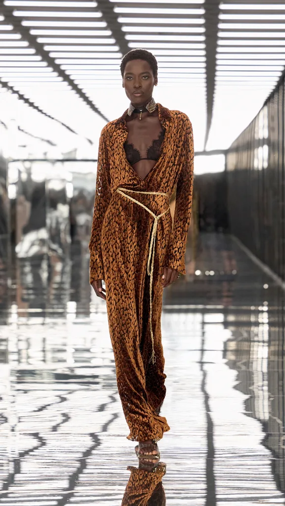 Model in an orange maxi dress