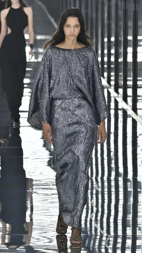 A model in a silver lurex skirt and top set