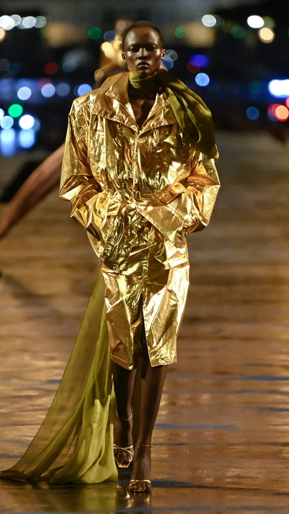 A model wearing a gold jacket and skirt set