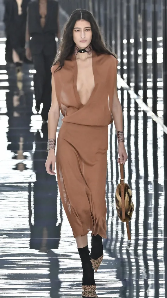 A model in a V-neck terracotta-coloured dress