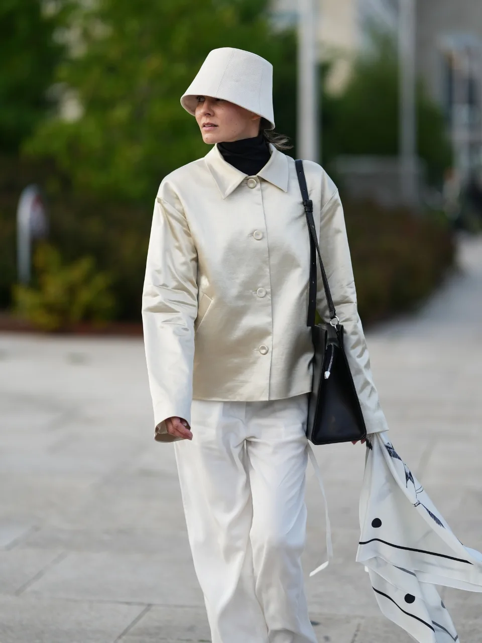 Woman wears white silk blazer at Copenhagen Fashion Week