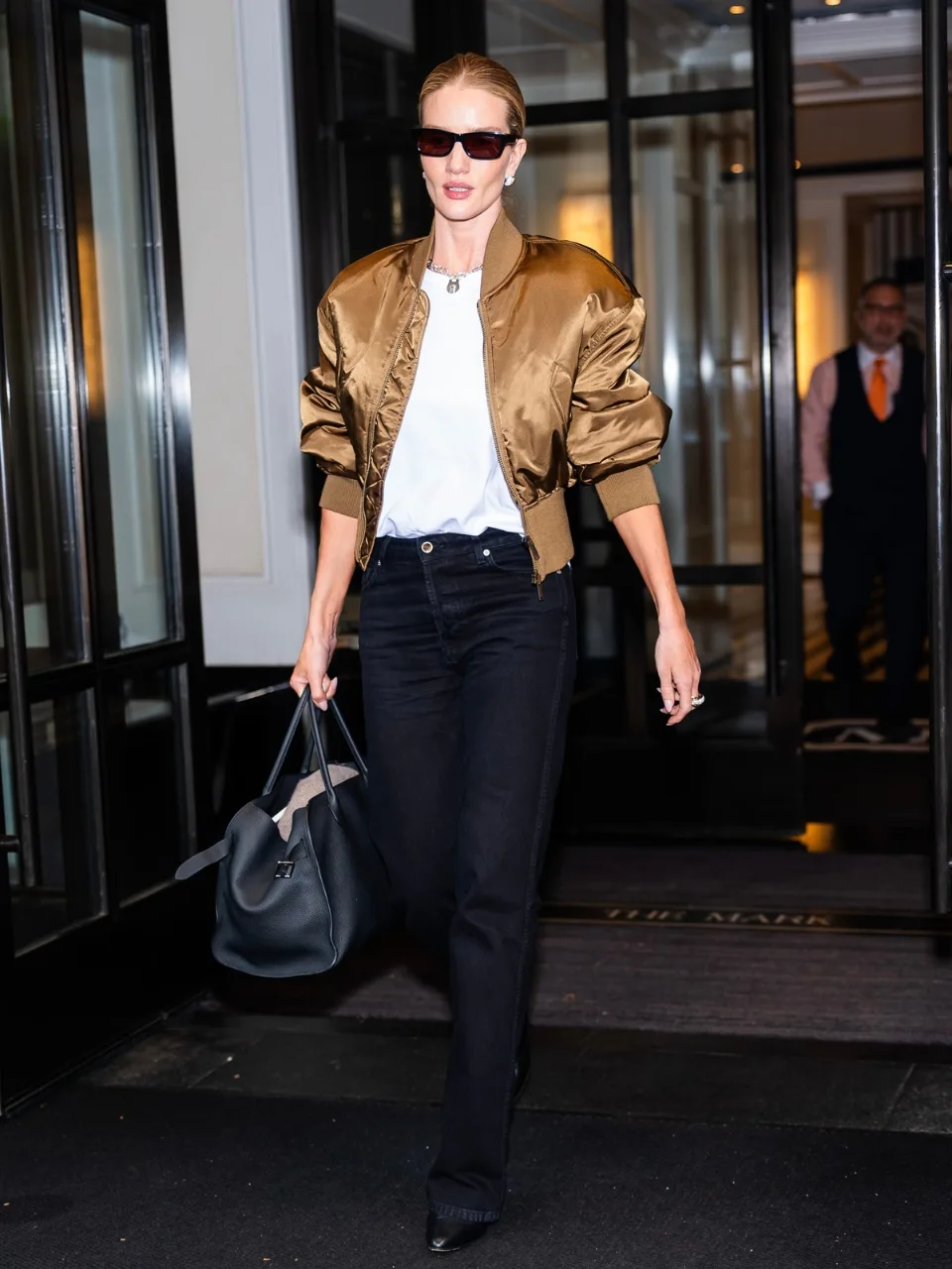 Rosie Huntington Whiteley wears a satin bomber jacket and black jeans