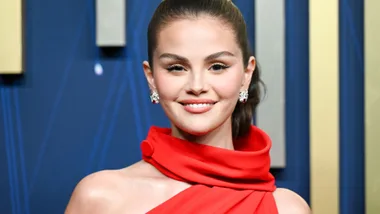 Selena Gomez wearing a vibrant red valentino dress and the 2025 Emmy Awards