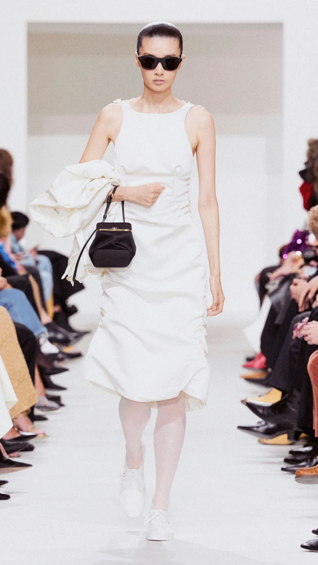 A model wearing a white dress