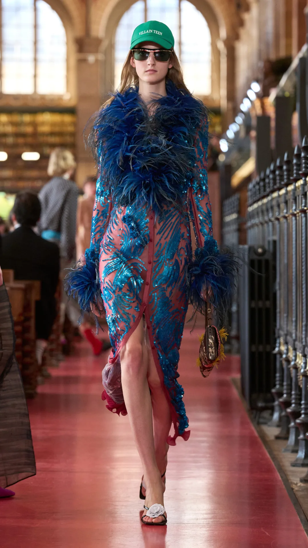 A model wearing an embellished blue and red dress
