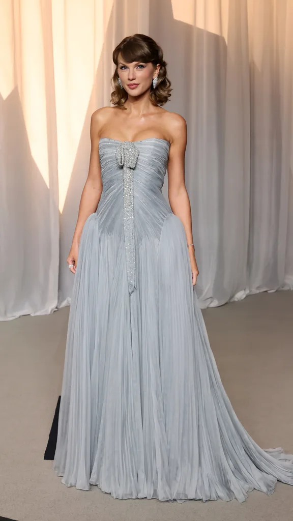 Taylor Swift wearing a blue dress.