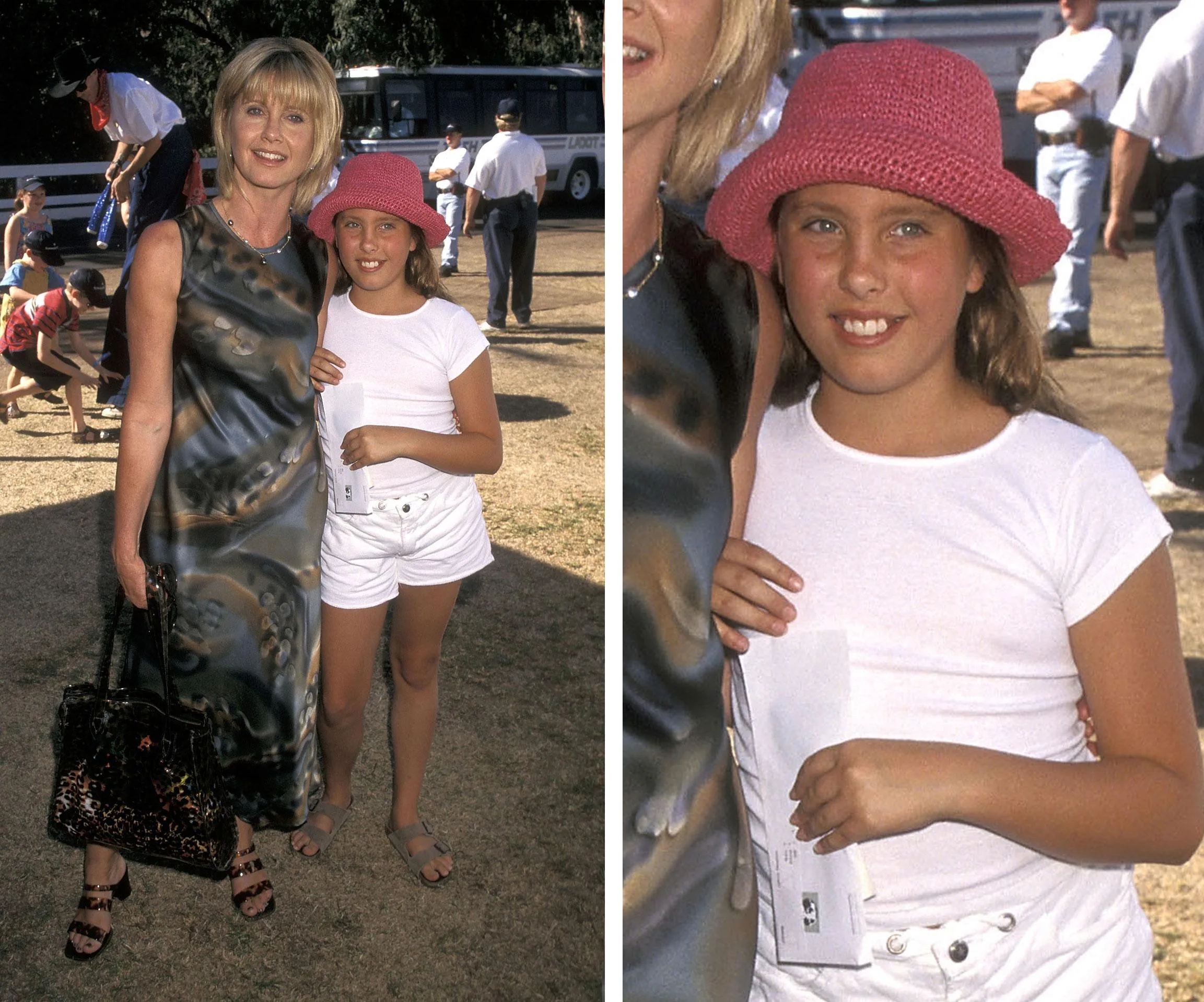 A woman in a patterned dress stands with a young girl in a pink hat and white outfit outdoors, both smiling at the camera.