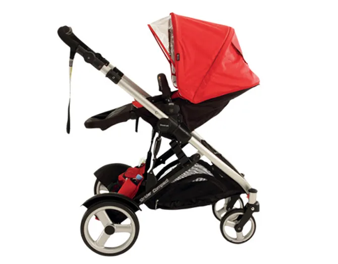 Red stroller with a silver frame, side view, featuring four wheels and an adjustable canopy.