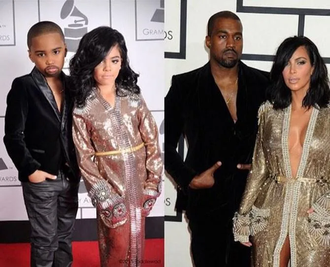 Children dressed as Grammy stars in matching outfits beside the original stars on the red carpet.