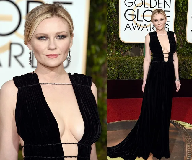 A woman in a black evening gown on the red carpet at the Golden Globe Awards.