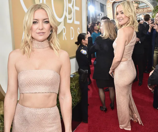 Woman in shimmering beige gown on the red carpet at Golden Globe Awards, posing for photos with people in the background.