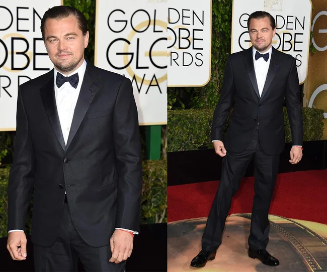 Man in a black tuxedo at the Golden Globe Awards, standing on a red carpet.