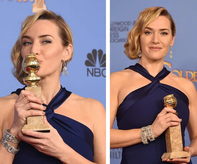Woman in a blue dress holds a Golden Globe trophy, smiling with short blond hair and wearing earrings.