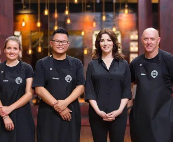 Nigella Lawson with MasterChef Australia contestants Chloe, Jimmy, and Miles in a warmly lit kitchen setting.