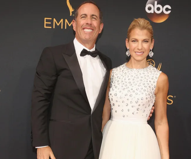 A man and woman pose together on the red carpet at an event, with "EMMYS" and "ABC" logos in the background.