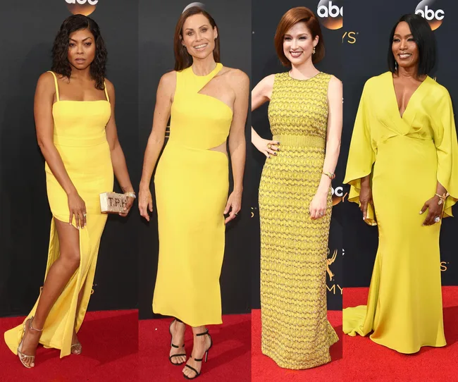 Four women in yellow dresses on a red carpet at an event, posing and smiling for photos.